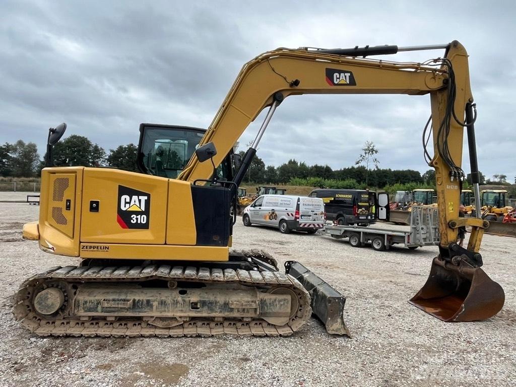 CAT 310 Середні екскаватори 7т. - 12т.
